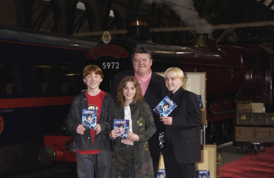 LONDON - MAY 08:  Actors, Robbie Coltrane, Rupert Grint, Emma Watson and Tom Felton at the 'Harry Potter and The Philosopher's Stone' DVD launch party held on platform 9 3/4, King's Cross Station on 8th May 2002, in London. (Photo by Dave Benett/Getty Images).