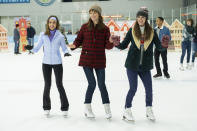 This image released by Hulu shows Alison Brie, Mackenzie Davis, and Mary Holland in a scene from "Happiest Season." (Lacey Terrell/Hulu via AP)