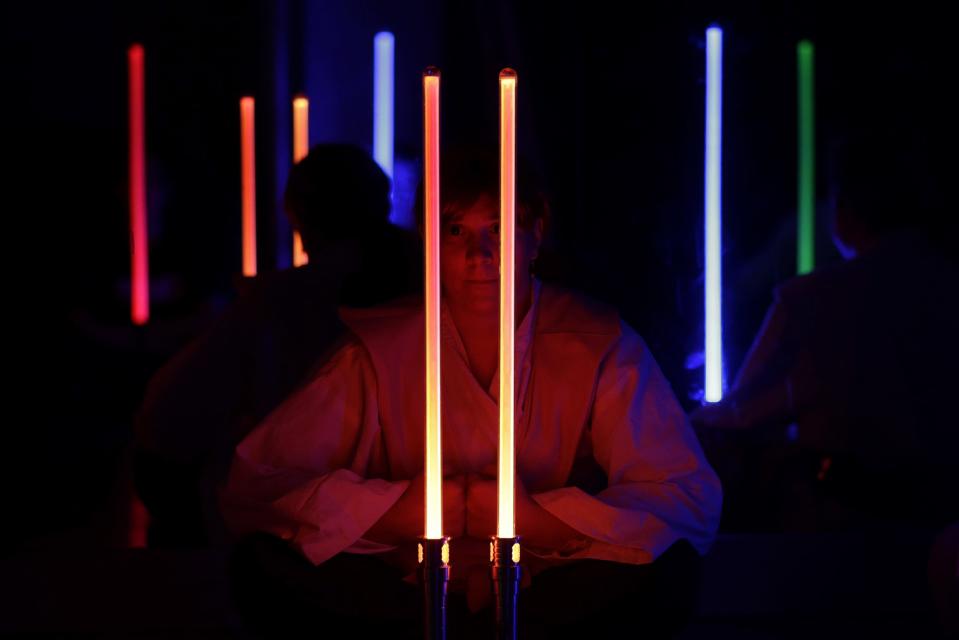 �Sophianna Ardinger meditates after a Golden Gate Knights class in San Francisco, Sunday, Feb. 10, 2013. A group of San Francisco Star Wars fans who want to travel to a galaxy not that far away have created a combat choreography class for Jedis-in-training with their weapon of choice: the light saber. (AP Photo/Jeff Chiu)