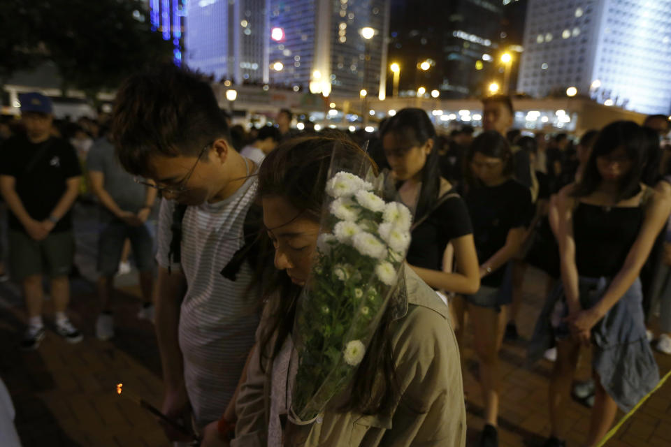 Attendees take part in a vigil to mourn the death of a woman in Hong Kong Saturday, July 6, 2019. The vigil is being held for the woman who fell to her death this week, one of three apparent suicides linked to ongoing protests over fears that freedoms are being eroded in this semi-autonomous Chinese territory. (AP Photo/Andy Wong)