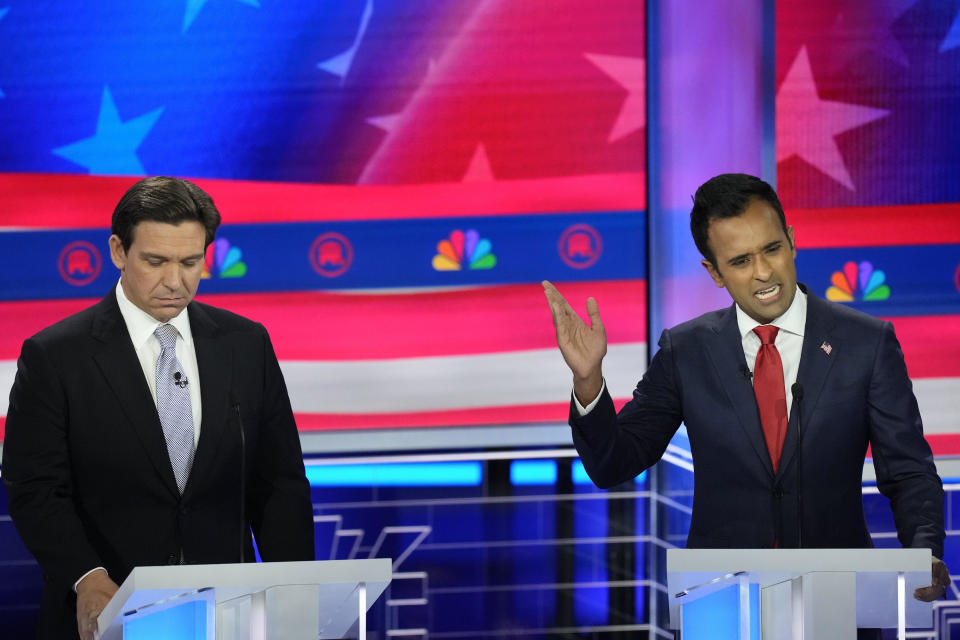 Republican presidential candidate businessman Vivek Ramaswamy speaks as Florida Gov. Ron DeSantis listens during a debate hosted by NBC News on Nov. 8, 2023, in Miami. / Credit: Rebecca Blackwell / AP