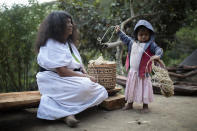 Juana, a 65-year old Arauco Indigenous woman, teaches weaving to her daughters in Nabusimake, Sierra Nevada de Santa Marta, Colombia, Tuesday, Jan. 17, 2023. The knowledge that the Arhuacos and the three other Indigenous peoples of the Sierra Nevada de Santa Marta, the Koguis, Wiwas y Kankuamos, has been declared Intangible Cultural Heritage by UNESCO. (AP Photo/Ivan Valencia)