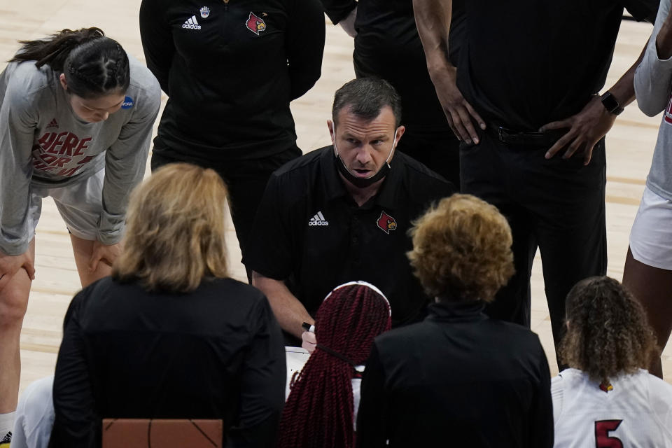 Louisville head coach Jeff Walz talks to his players during the first half of a college basketball game against Oregon in the Sweet Sixteen round of the women's NCAA tournament at the Alamodome in San Antonio, Sunday, March 28, 2021. (AP Photo/Eric Gay)