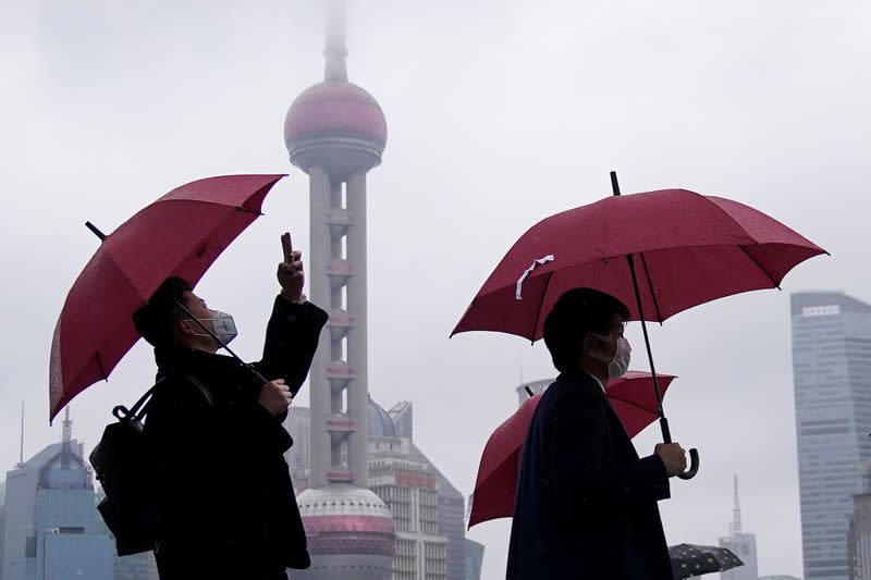 People wearing masks are seen at the Bund in Shanghai