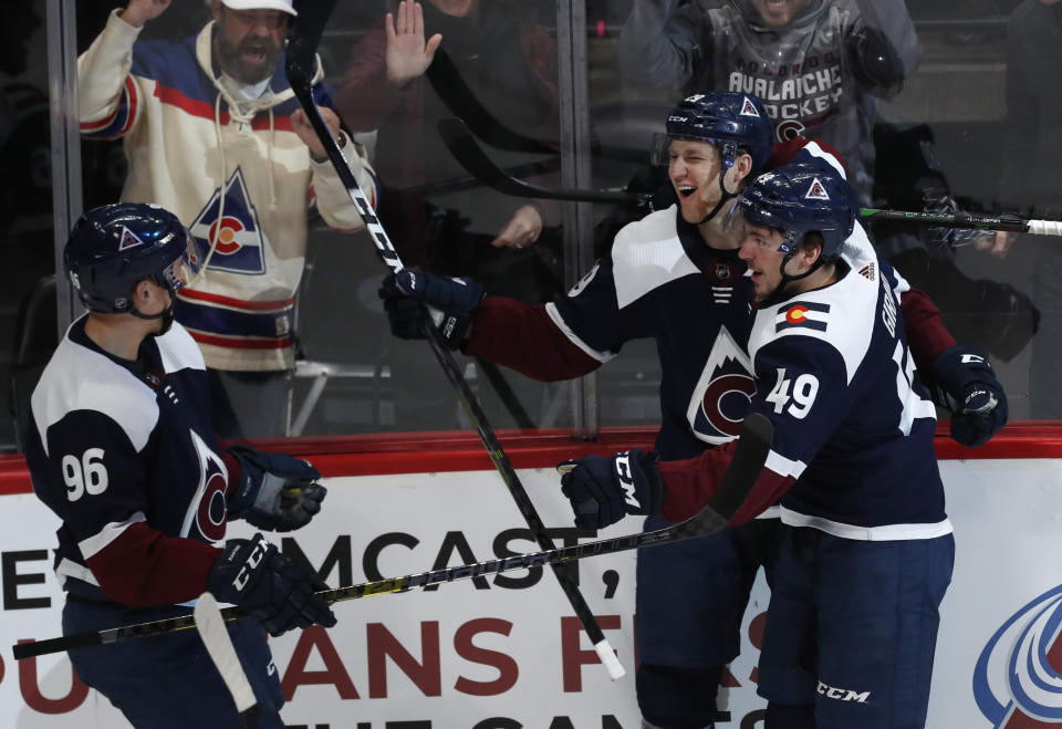 Colorado Avalanche center Nathan MacKinnon, center, celebrates scoring a goal with defenseman Samuel Girard, right, and right wing Mikko Rantanen in the first period of an NHL hockey game against the St. Louis Blues Saturday, Jan. 18, 2020, in Denver. (AP Photo/David Zalubowski)