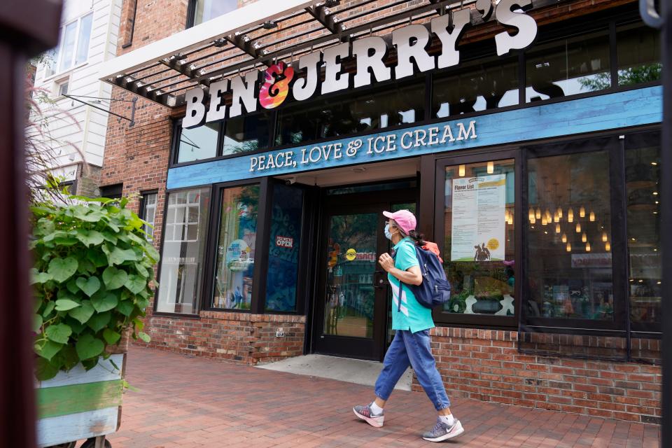 A woman walks past the Ben & Jerry's Ice Cream shop, Tuesday, July 20, 2021, in Burlington, Vt. Ben & Jerry's said Monday it was going to stop selling its ice cream in the Israeli-occupied West Bank and contested east Jerusalem, saying the sales in the territories sought by the Palestinians are "inconsistent with our values". (AP Photo/Charles Krupa)