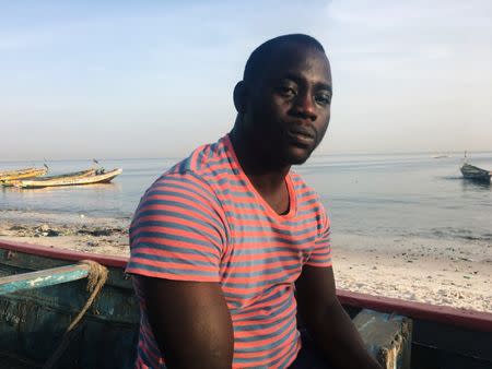 Assane Diallo, a migrant who is preparing to travel by boat from Senegal to the Canary Islands, poses for a picture in Dakar, Senegal November 28, 2018. REUTERS/ Edward McAllister