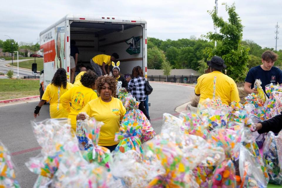 Volunteer Paula Tate helps to unload hundreds of handcrafted Easter baskets before the annual Easter egg hunt at the Como Community Center in Fort Worth on Saturday, April 8, 2023. Lady Jag’s Social & Charity Club provided more than 400 free baskets filled with toys and candy.