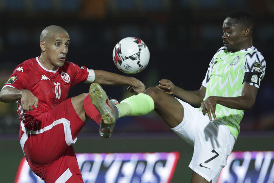 Tunisia's Wahbi Khazri, left, and Nigeria's Ahmed Musa fight for the ball during the African Cup of Nations third place soccer match between Nigeria and Tunisia in Al Salam stadium in Cairo, Egypt, Wednesday, July 17, 2019. (AP Photo/Hassan Ammar)