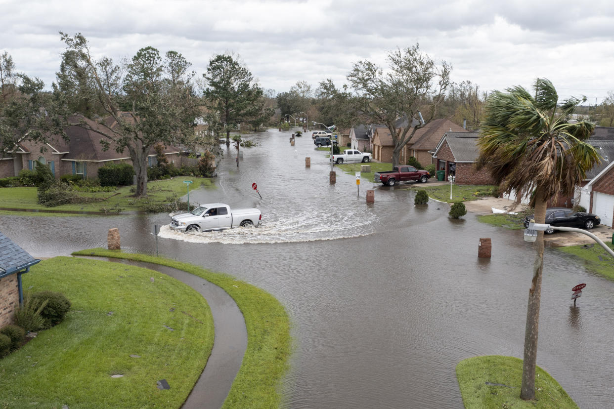 A truck drives through the flooded streets of Indigo Estates after Hurricane Ida moved through Monday, Aug. 30, 2021, in LaPlace, La. (Steve Helber/AP Photo)