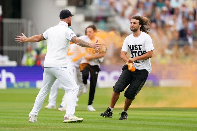 England captain Ben Stokes bars the way of a Just Stop Oil protester