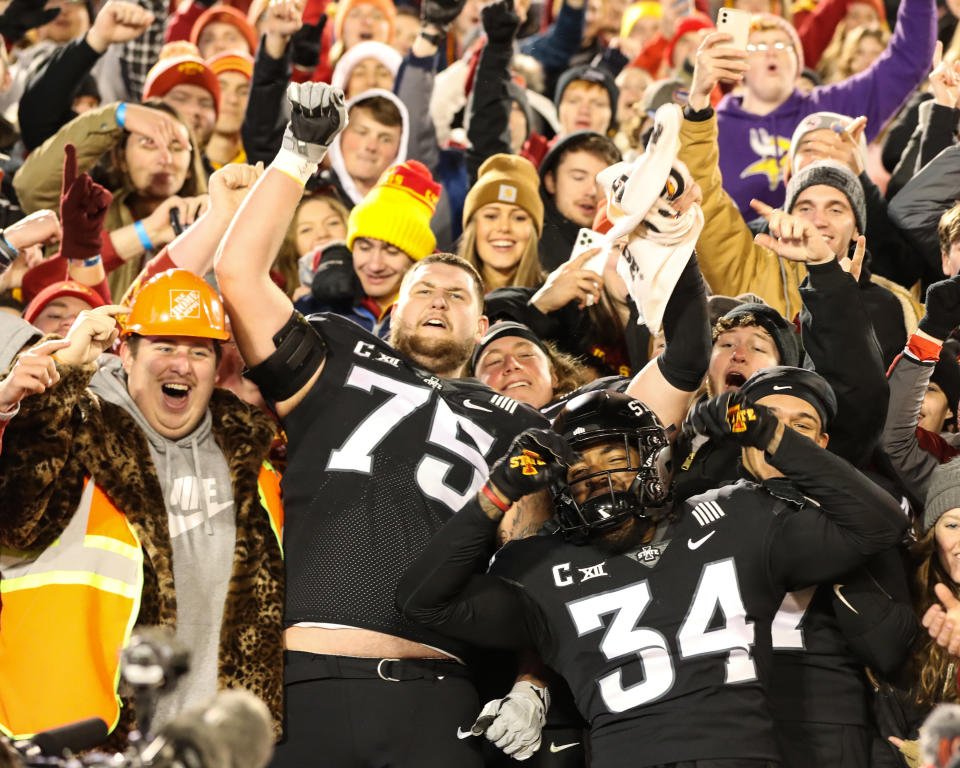 Nov 26, 2021; Ames, Iowa, USA; Iowa State Cyclones offensive lineman Sean Foster (75) and linebacker O’Rien Vance (34) celebrate with students in the stands after the win against the TCU Horned Frogs at Jack Trice Stadium. Mandatory Credit: Reese Strickland-USA TODAY Sports