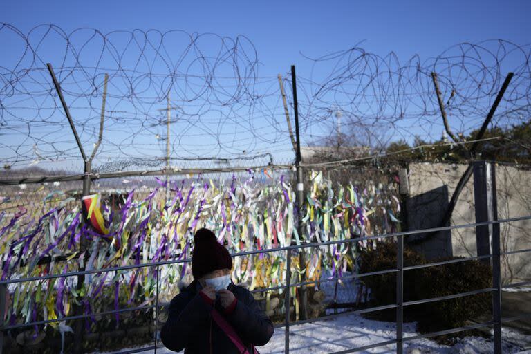 Un visitante recorre cerca de cintas con mensajes que desean la paz entre las dos Coreas colgadas en las alambradas del Pabellón Imjingak en Paju, Corea del Sur.