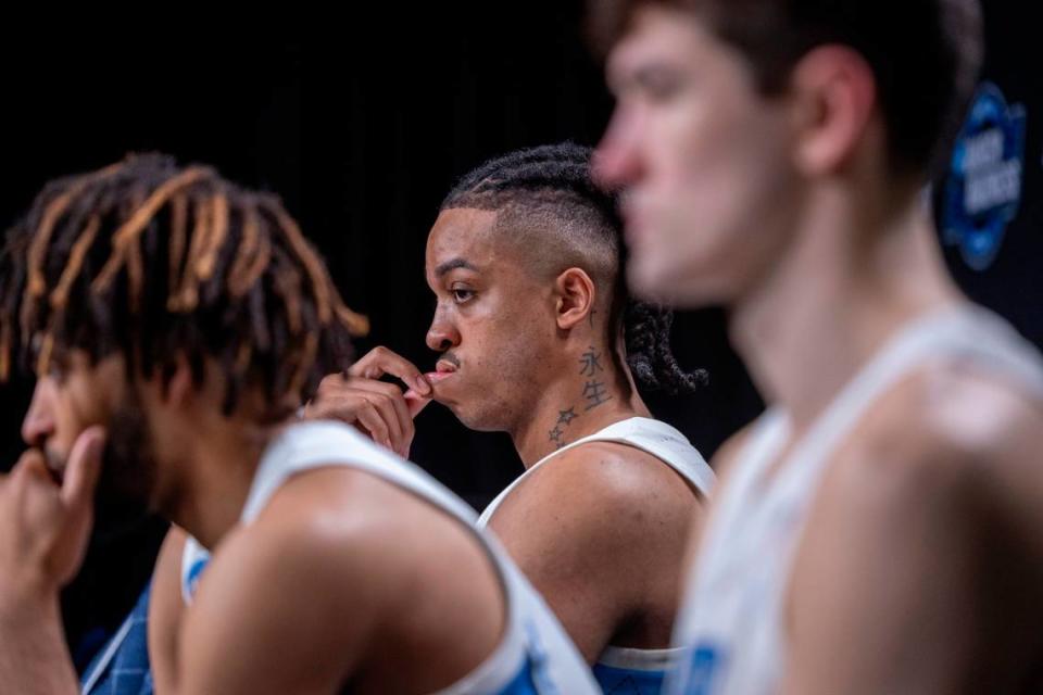 North Carolina’s Armando Bacot (5) tugs on his lip as he and teammates R.J. Davis (4) and Cormac Ryan (3) take questions from the media following their 89-87 loss to Alabama in the West Regional Sweet Sixteen on Thursday, March 28, 2024 at Crypto.com Arena in Los Angeles, CA.