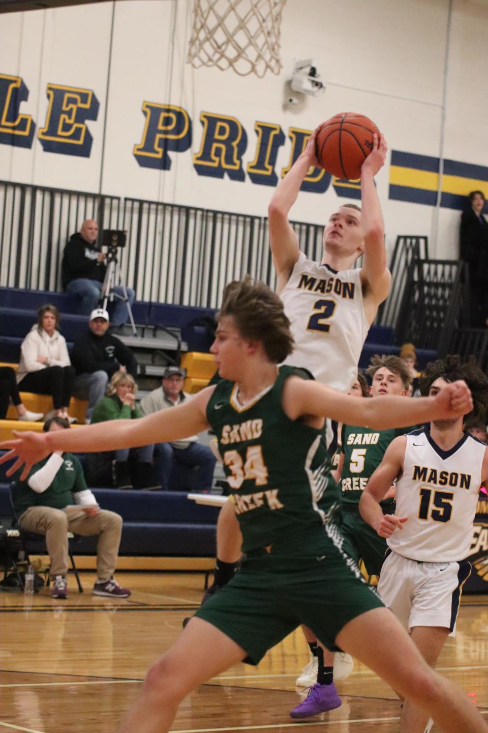 Carson Brown of Erie Mason goes up for a shot against Sand Creek on Thursday, January 5, 2023.