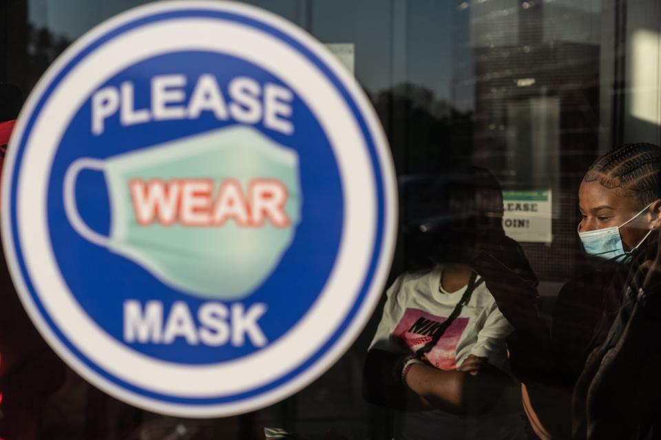 A sign encouraging students to wear masks is posted at the entry of Ecorse High School during the first day of school on Sept. 7, 2021.