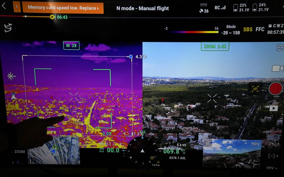 A drone pilot points on a screen the live images from a long-range drone equipped with thermal imaging cameras and a sophisticated early warning system, in the northern suburb of Nea Erithrea, Athens, Greece, Thursday, Aug. 10, 2023. Greece is plagued by hundreds of wildfires each summer. To protect their area from potentially deadly blazes, a group of residents from a suburb in northern Athens have joined forces to hire a company using long-range drones equipped with thermal imaging cameras and a sophisticated early warning system to catch fires before they can spread. (AP Photo/Thanassis Stavrakis)