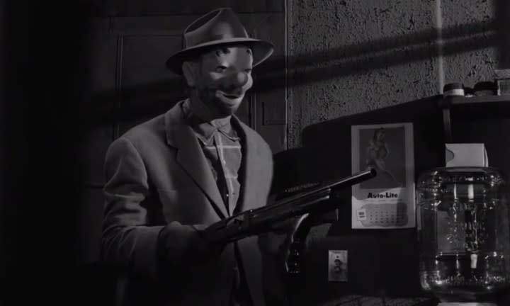 A masked man holding a rifle in "The Killing."