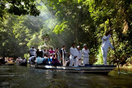 FILE PHOTO: Roman Catholic pilgrims travel as they accompany the statue of Our Lady of Conception during an annual river procession and pilgrimage along the Caraparu River in Santa Izabel do Para