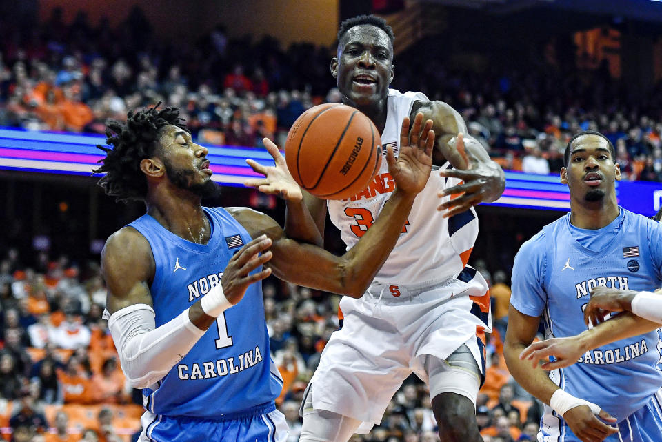 North Carolina guard Leaky Black, left, and Syracuse forward Bourama Sidibe reach for a rebound during the second half of an NCAA college basketball game in Syracuse, N.Y., Saturday, Feb. 29, 2020. North Carolina defeated Syracuse 92-79. (AP Photo/Adrian Kraus)