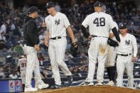 New York Yankees manager Aaron Boone, left, removes pitcher Clay Holmes, second from left, from a baseball game in the ninth inning against the San Francisco Giants, Saturday, April 1, 2023, in New York. (AP Photo/Mary Altaffer)