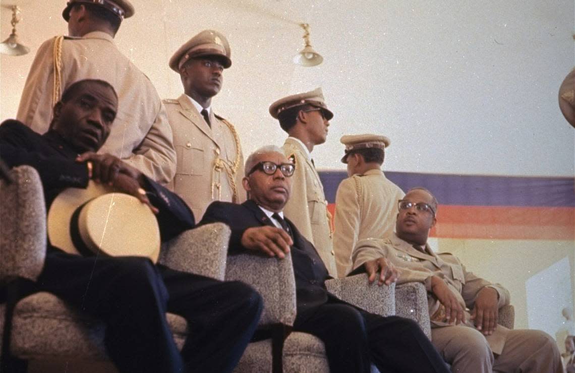Dr. Francois “Papa Doc” Duvalier, seated center, who had himself declared ‘President for Life,’ is pictured in a 1963 photo. He would be succeeded by his son.  