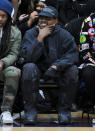 <p>Kanye West smiles sitting courtside at the DONDA Academy homecoming basketball game in Whittier, California on Dec. 22.</p>