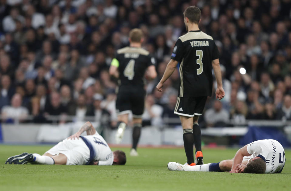 Tottenham's Jan Vertonghen, right, and Tottenham's Toby Alderweireld, left, lie on the pitch after colliding during the Champions League semifinal first leg soccer match between Tottenham Hotspur and Ajax at the Tottenham Hotspur stadium in London, Tuesday, April 30, 2019. (AP Photo/Frank Augstein)