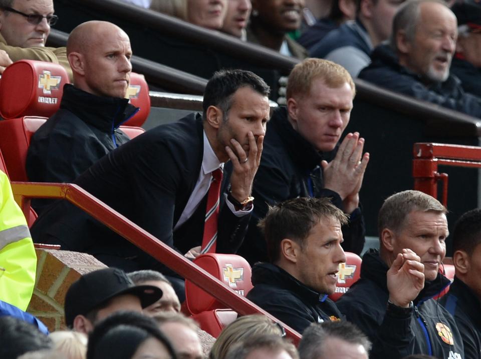 Manchester United's manager Giggs reacts with coaches Butt and Scholes during their English Premier League match against Norwich City in Manchester