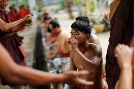 A patient drinks a vomit-inducing medication made with plants and roots at the rehabilitation and detox area at Wat Thamkrabok monastery in Saraburi province, Thailand, February 3, 2017. REUTERS/Jorge Silva