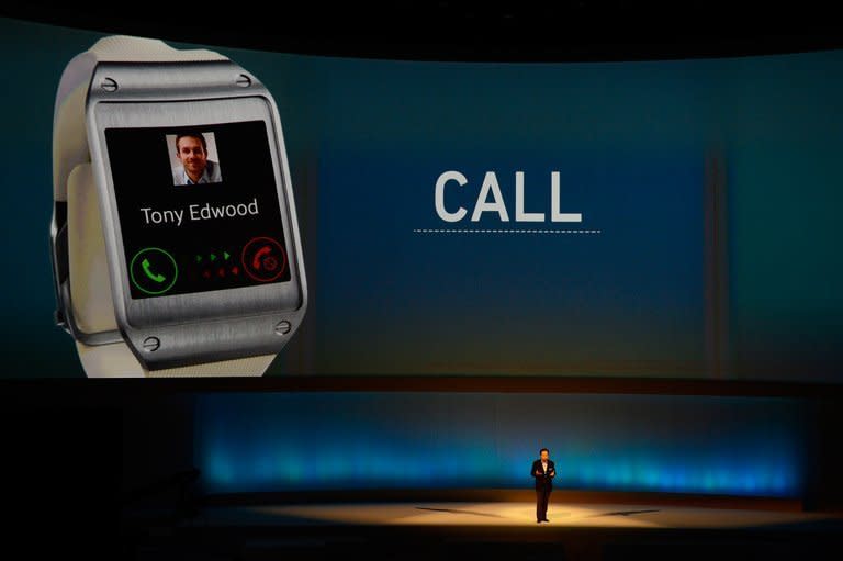 JK Shin, head of Samsung's mobile division, presents the Galaxy Gear smartwatch at the IFA trade fair in Berlin on September 4, 2013. The Galaxy Gear allows users to make calls, receive texts and emails and take photos