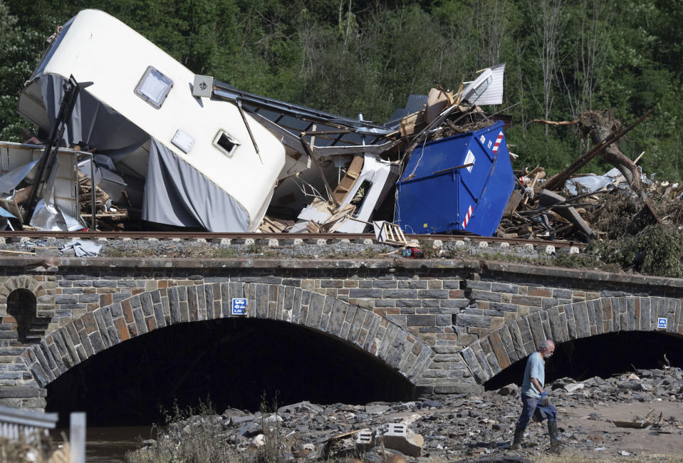 Caravans, cars and mobile homes that were swept away by the flood wave hang together on a bridge over the River Ahr, in Altenahr, western Germany, Sunday, July 18, 2021. Heavy rains caused mudslides and flooding in the western part of Germany. Multiple have died and are missing as severe flooding in Germany and Belgium turned streams and streets into raging, debris-filled torrents that swept away cars and toppled houses. (Boris Roessler/dpa via AP)