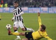 Juventus' Carlos Tevez (L) is challenged by Borussia Dortmund's Oliver Kirch during their Champions League round of 16 first leg soccer match at the Juventus stadium in Turin February 24, 2015. REUTERS/Alessandro Bianchi (ITALY - Tags: SPORT SOCCER)