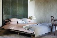 <p>Be inventive with salvaged finds to create a look that’s original and stylish. Here, a mattress rests on old builders’ palettes, while a wall of scuffed steel lockers acts as a headboard and a smart storage solution. The layered dusky pink bedding elevates these time-worn finds to something far more luxurious.</p>