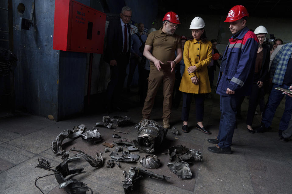 German's Foreign Minister Annalena Baerbock and Ukrainian Energy Minister Herman Halushchenko look on fragments of Russian rocket during official visit to a thermal power plant which was destroyed by a Russian rocket attack in Ukraine, Tuesday, May 21, 2024. (AP Photo/Evgeniy Maloletka)
