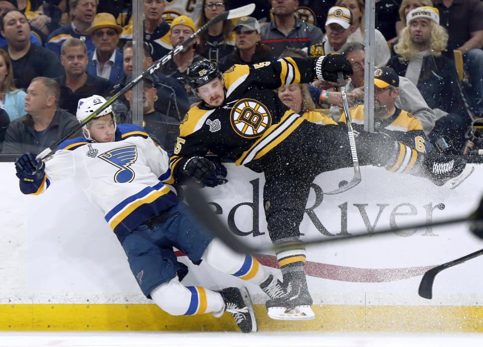 Boston Bruins' Noel Acciari (55) checks St. Louis Blues' Vince Dunn (29) to the ice during the first period in Game 5 of the NHL hockey Stanley Cup Final, Thursday, June 6, 2019, in Boston. (AP Photo/Michael Dwyer)