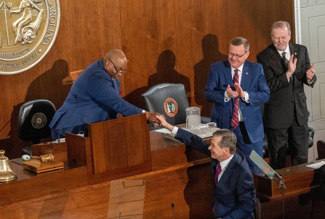 Gov. Roy Cooper shakes hands with Lt. Gov. Mark Robinson as House Speaker Tim Moore and Senate Leader Phil Berger look on before Cooper deliverd his State of the State address to a joint session of the N.C. General Assembly on Monday, March 6, 2023.