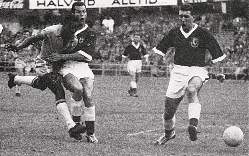 17-year-old Brazilian forward Pele (L) kicks the ball past two Welsh defenders during the World Cup quarterfinal - AFP