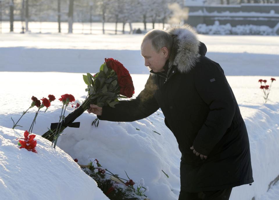 Russian President Vladimir Putin places flowers at the Piskaryovskoye Cemetery, in St. Petersburg, Russia, Sunday, Jan. 27, 2019, where most of the Leningrad Siege victims were buried during World War II. The Russian city of St. Petersburg marked the 75th anniversary of the end of the World War II siege by Nazi forces. The siege of the city, then called Leningrad, lasted nearly two and a half years until the Soviet Army drove the Nazis away on Jan. 27, 1944. (Mikhail Klimentyev, Sputnik, Kremlin Pool Photo via AP)