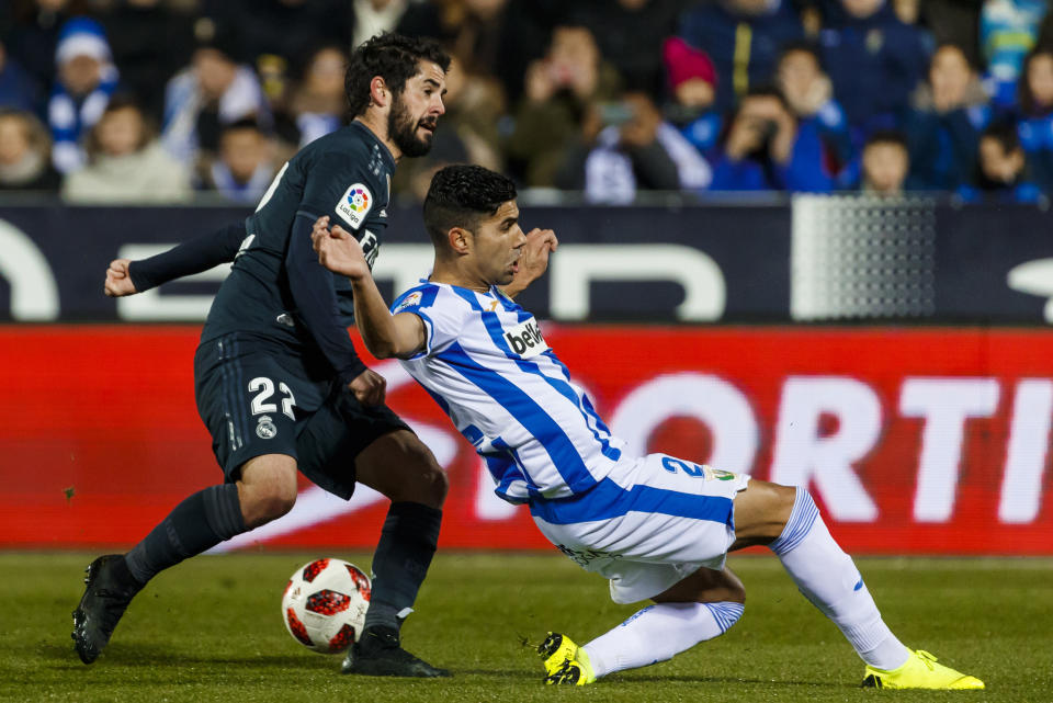 Real Madrid's Isco Alarcon, left, duels for the ball with Leganes' Juanfran Moreno during a Spanish Copa del Rey soccer match between Leganes and Real Madrid at the Butarque stadium in Leganes, Spain, Wednesday, Jan. 16, 2019. (AP Photo/Valentina Angela)