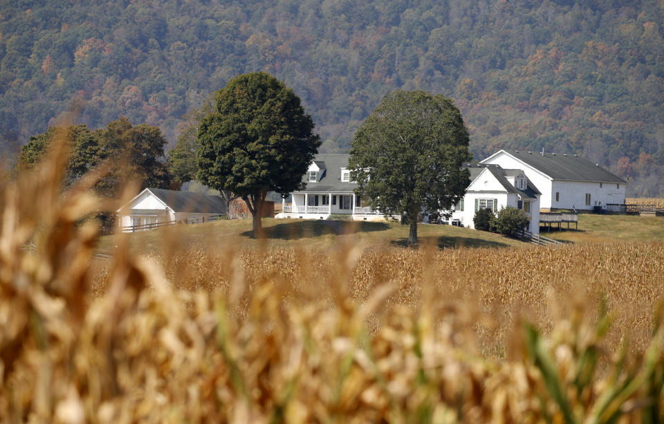 This Oct. 1, 2019 photo shows a farm house on a farm owned by the family of West Virginia Gov. Jim Justice near Lewisburg, W.Va. Justice Farms of North Carolina raked in tens of thousands of taxpayer dollars under a subsidy program President Donald Trump set up to help farmers hurt by his trade war with China. (AP Photo/Steve Helber)