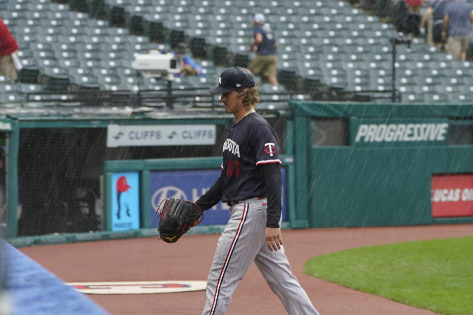 Minnesota Twins pitcher Joe Ryan walks off the field during a rain delay in the third inning of a baseball game against the Cleveland Guardians, Wednesday, Sept. 6, 2023, in Cleveland. (AP Photo/Sue Ogrocki)