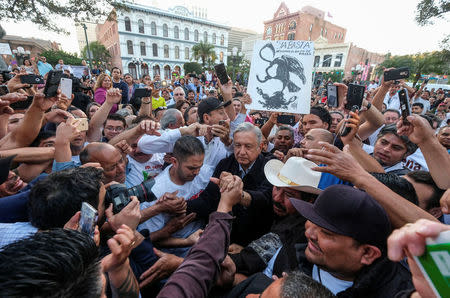 Mexican politician Andres Manuel Lopez Obrador, center, leader of the National Regeneration Movement (MORENA) party greets supporters as he arrives for a meeting at Plaza Olivera in Los Angeles, California, U.S., February 12, 2017. REUTERS/Ringo Chiu