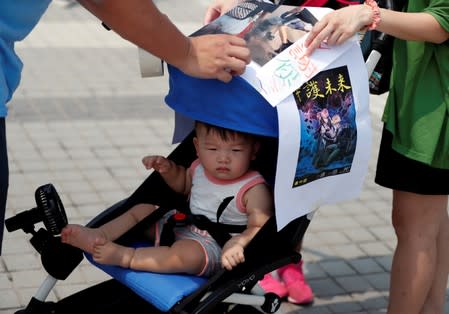 A family member participates in a protest rally titled "Guard Our Children's Future" at Edinburgh Place in Hong Kong, China