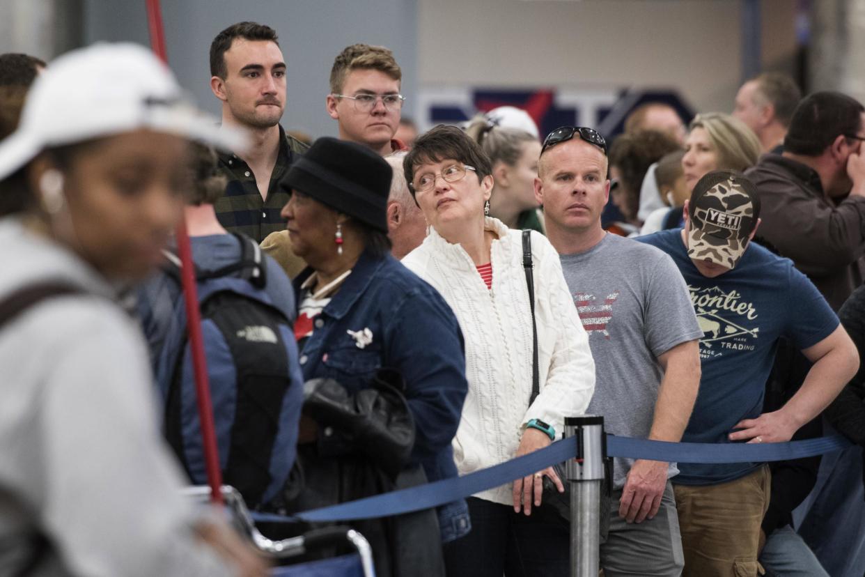 People wait in line to rebook flights at Hartfield-Jackson Atlanta International Airport: AP Photo John Amis