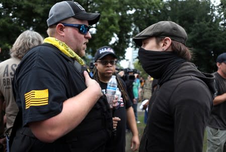 A Proud Boy and a counter protester exchange words at a rally in Portland, Oregon