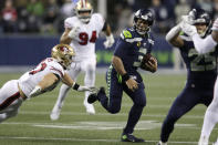 Seattle Seahawks quarterback Russell Wilson (3) is chased by San Francisco 49ers' Nick Bosa on a carry during the second half of an NFL football game, Sunday, Dec. 29, 2019, in Seattle. (AP Photo/Stephen Brashear)