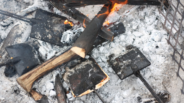 metal pie irons in campfire