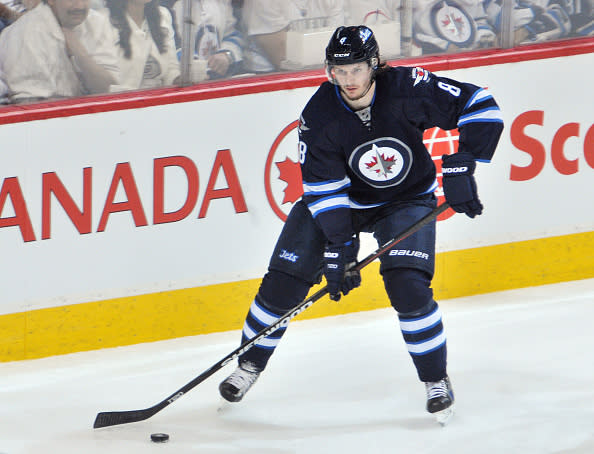 WINNIPEG, CANADA - APRIL 22: Jacob Trouba #8 of the Winnipeg Jets plays the puck during second period action against the Anaheim Ducks in Game Four of the Western Conference Quarterfinals during the 2015 NHL Stanley Cup Playoffs on April 22, 2015 at the MTS Centre in Winnipeg, Manitoba, Canada. The Ducks defeated the Jets 5-2. (Photo by Lance Thomson/NHLI via Getty Images)