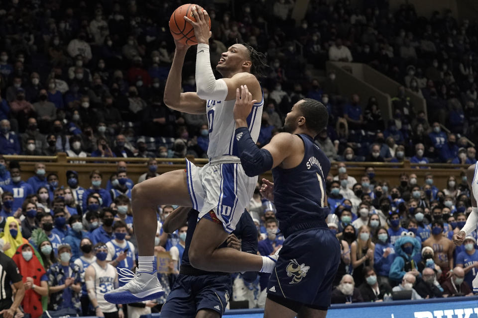 Duke forward Wendell Moore Jr. (0) drives to the basket against Georgia Tech guard Kyle Sturdivant (1) during the second half of an NCAA college basketball game in Durham, N.C., Tuesday, Jan. 4, 2022. (AP Photo/Gerry Broome)
